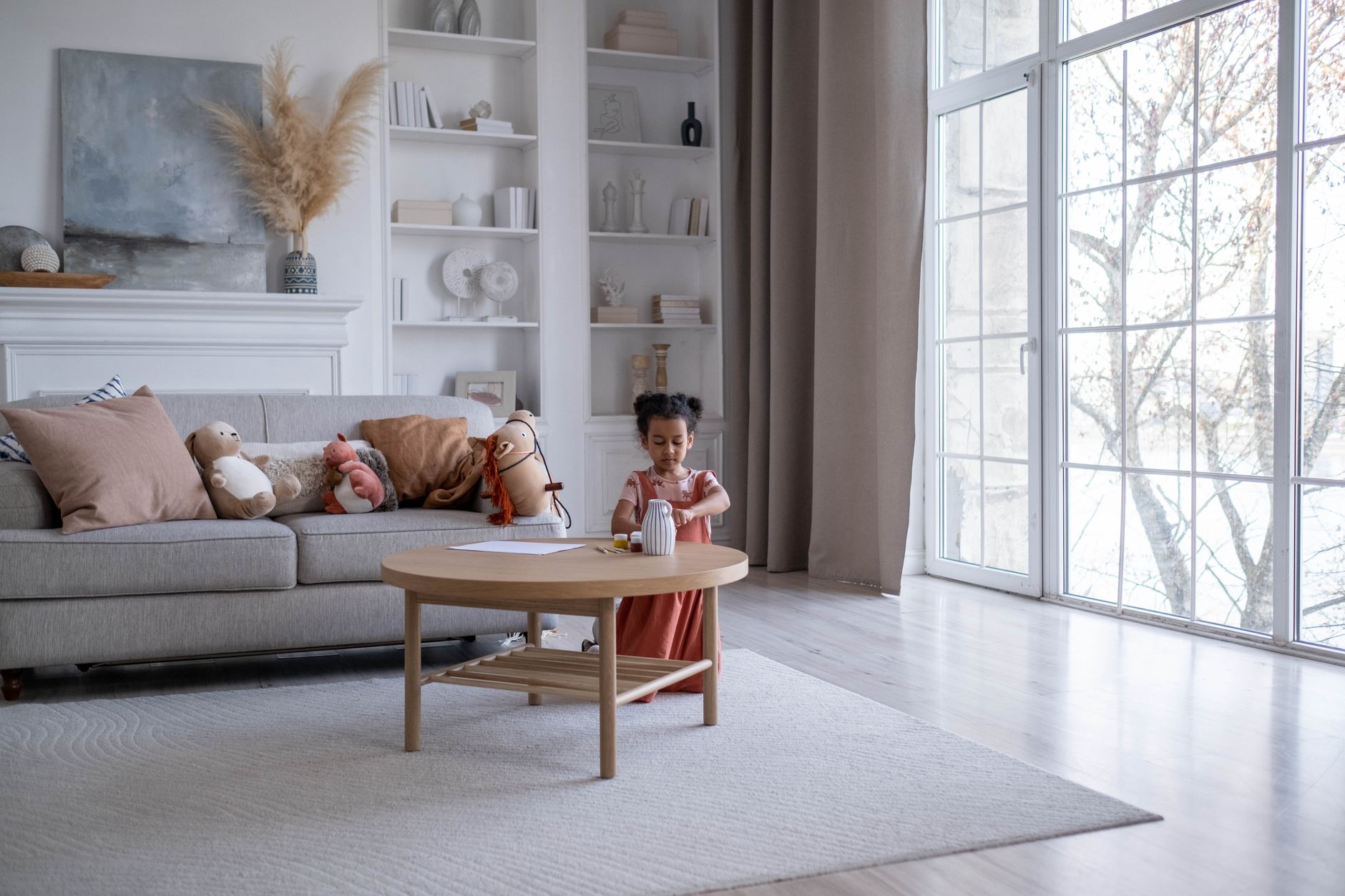 A family living room with a sofa, coffee table, and clear walking space near natural light