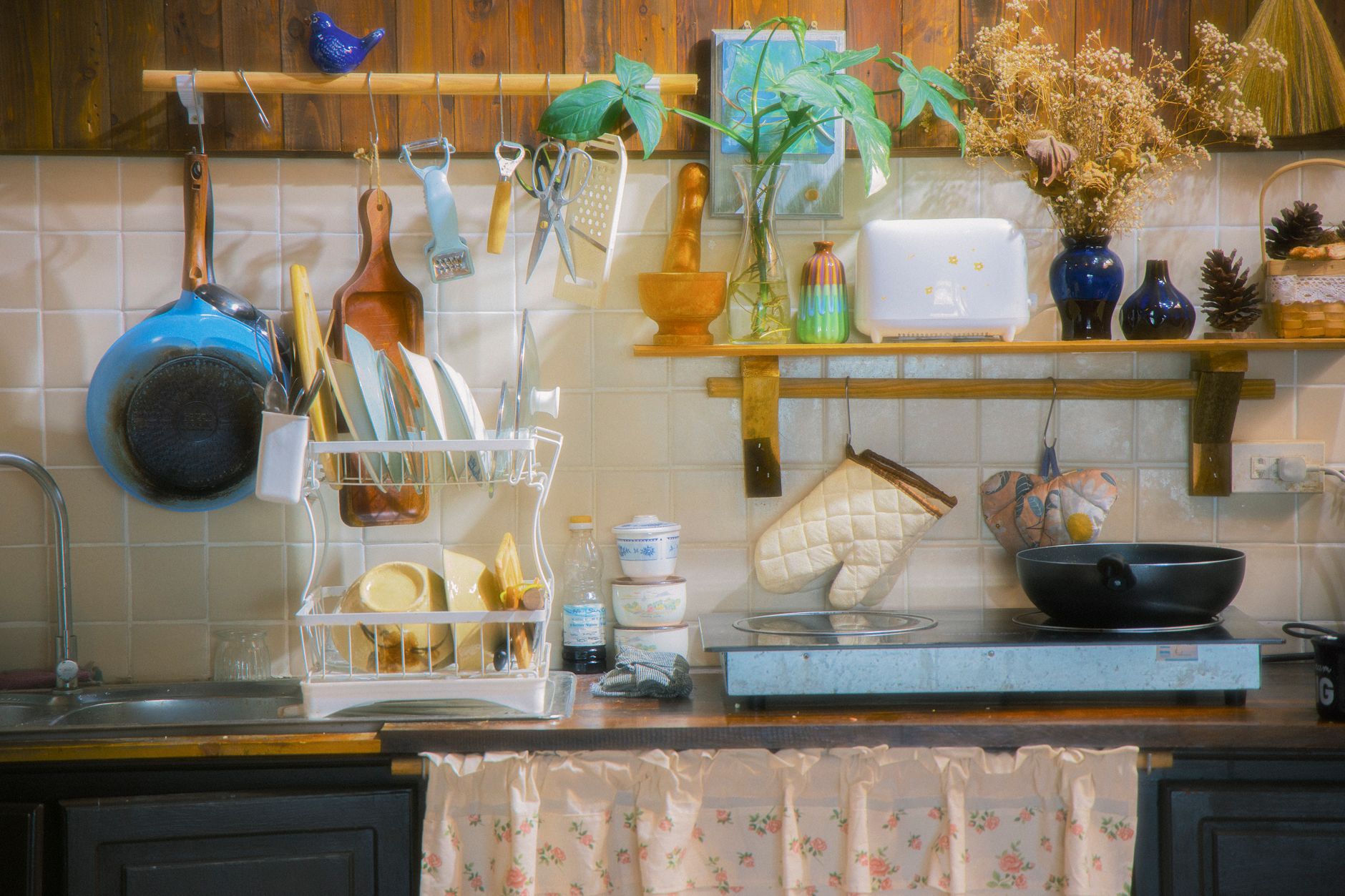 Warm kitchen with open shelves holding everyday dishes and glassware