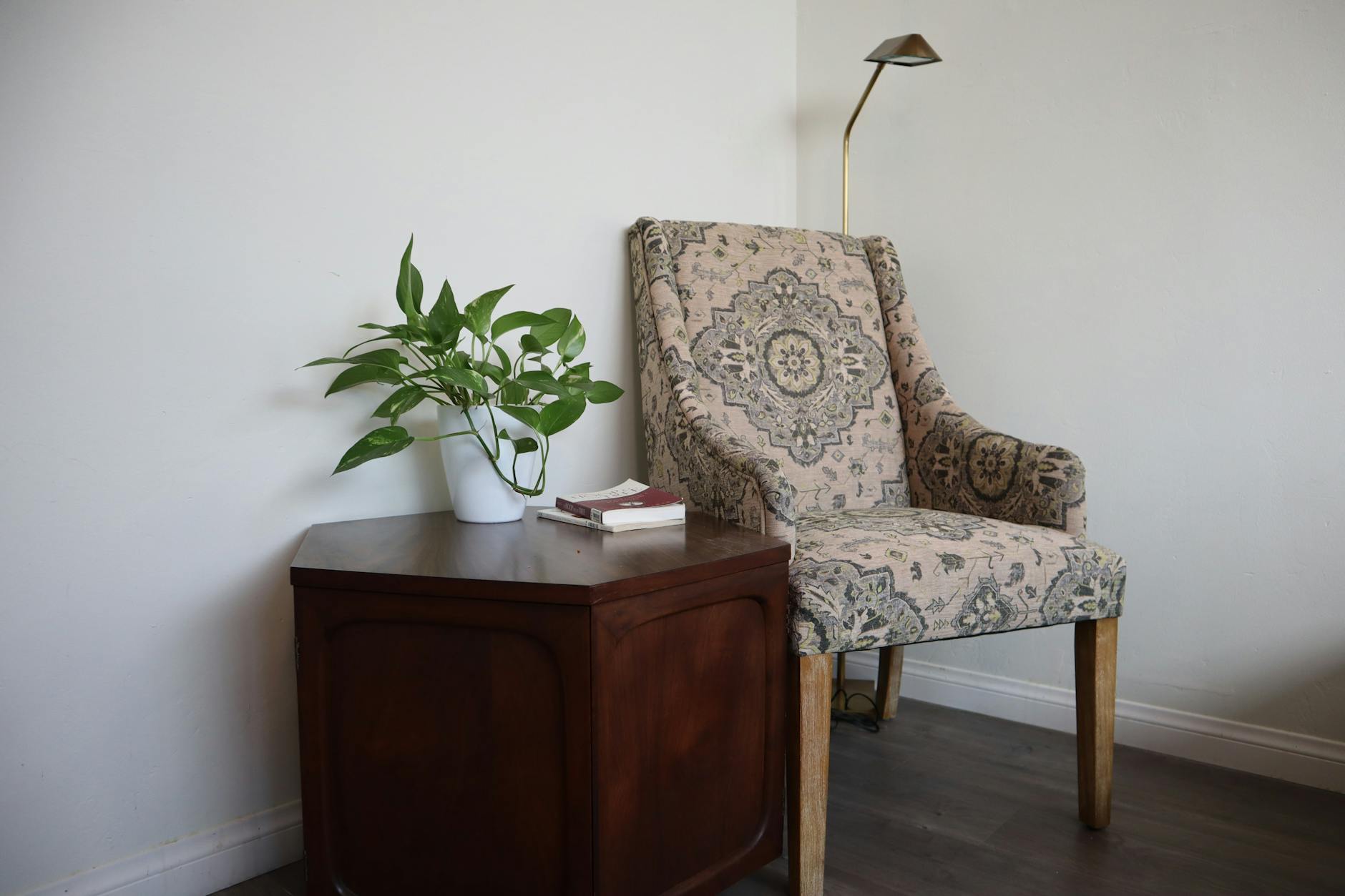 cozy reading corner with chair, lamp, and a small side table in a lived-in home