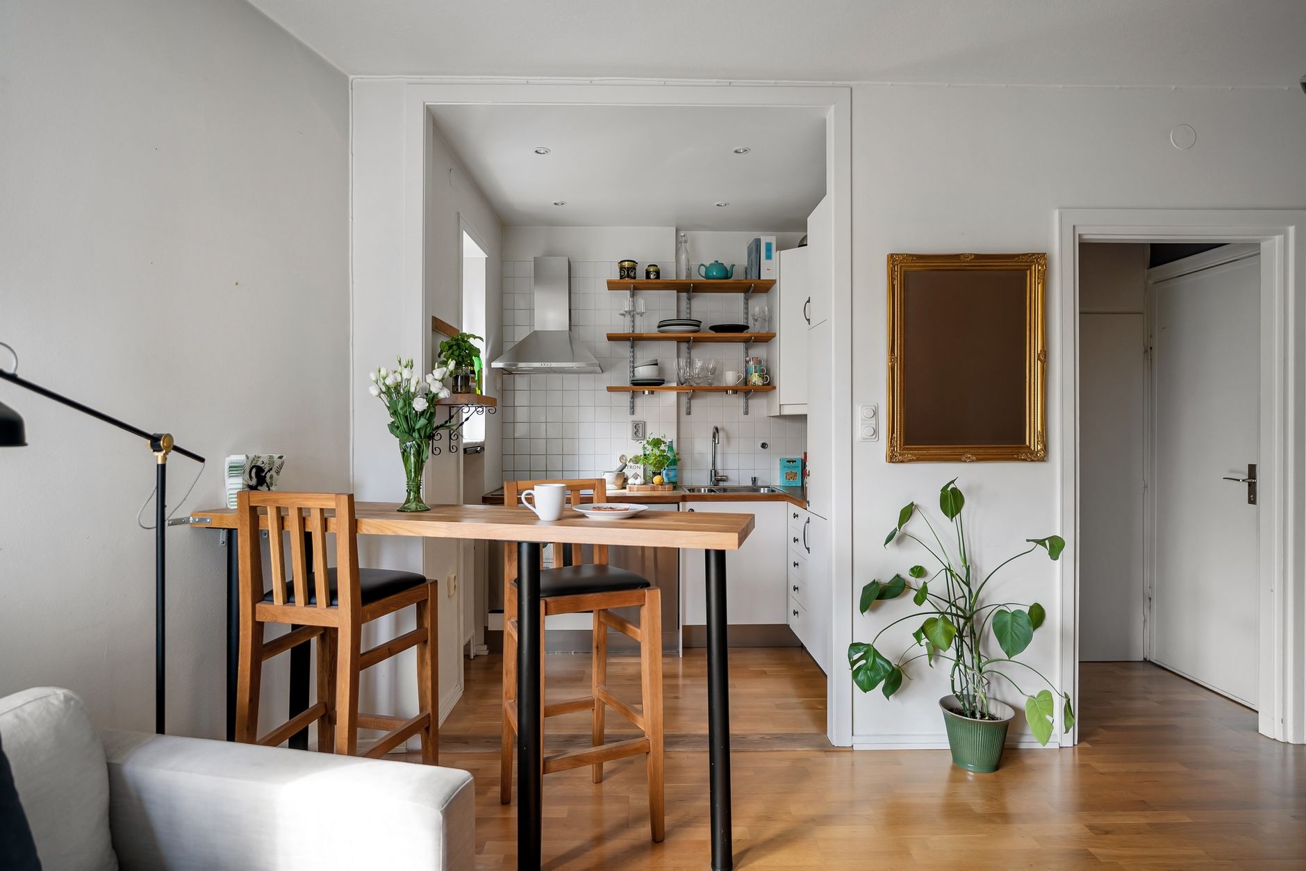 A cozy home corner with a small potted plant and natural wood accents