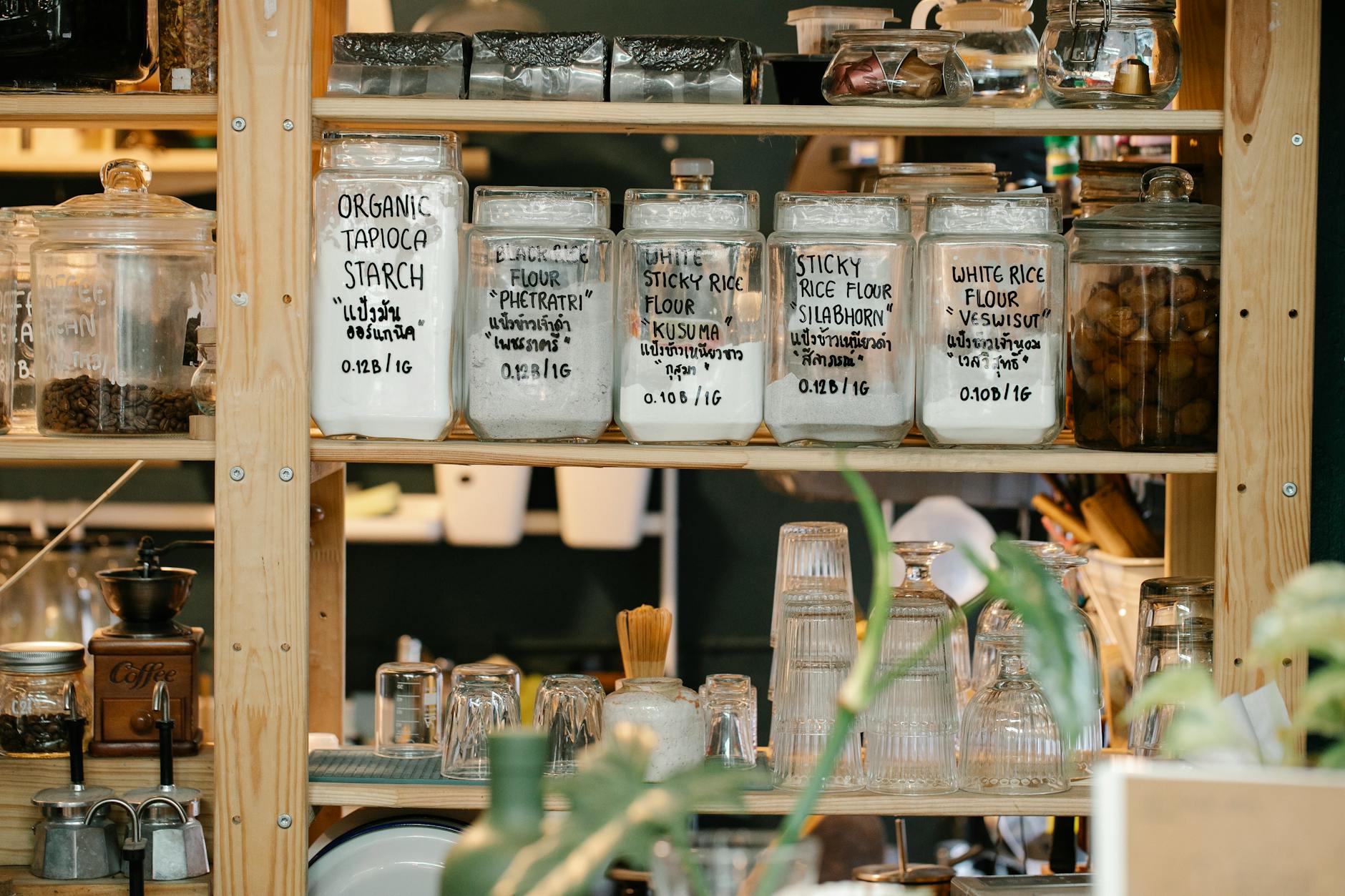A neatly organized pantry with labeled containers, fresh produce, and warm lighting in a cozy kitchen.