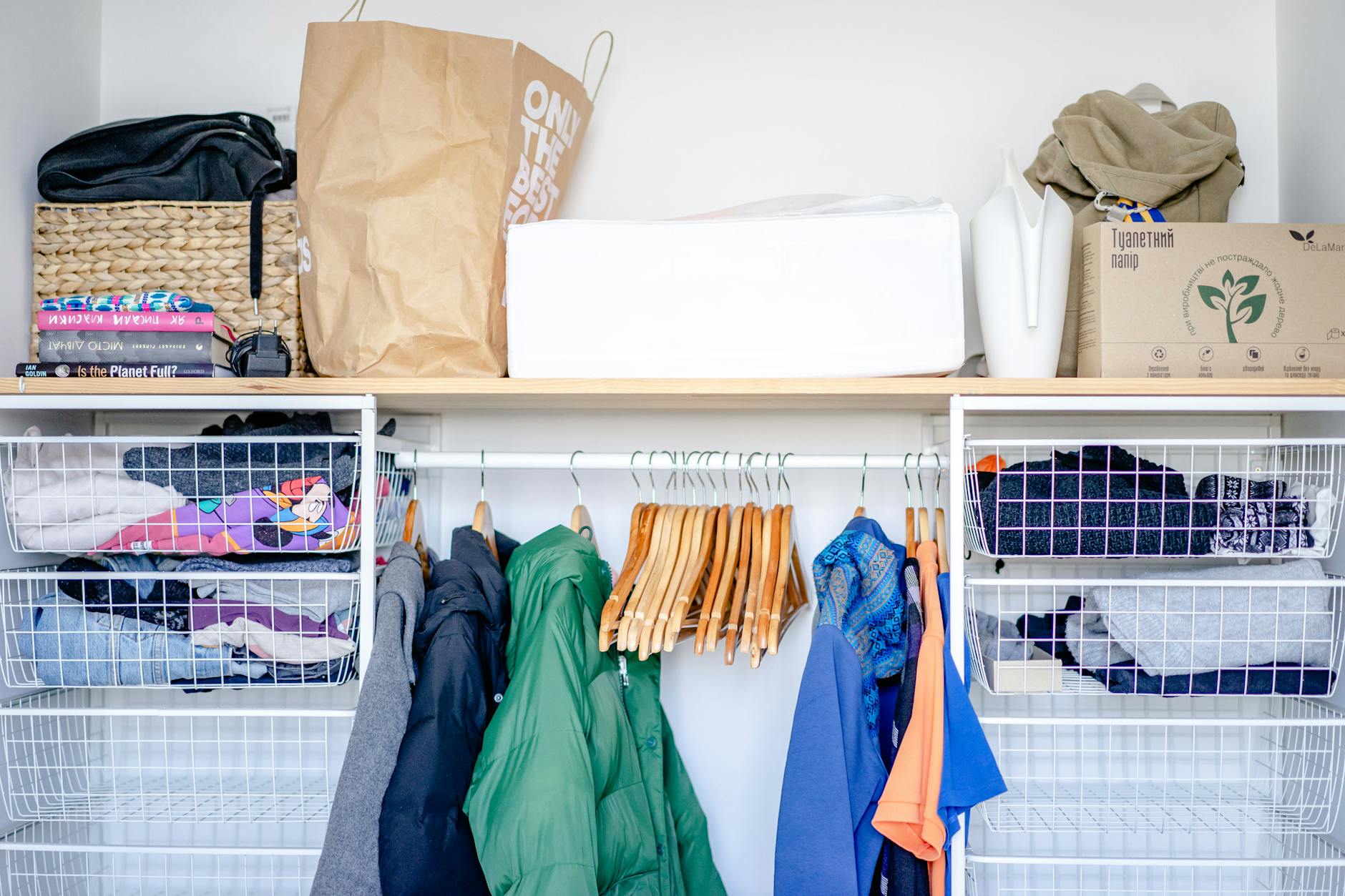 A neatly packed suitcase beside a tidy bedroom with storage baskets