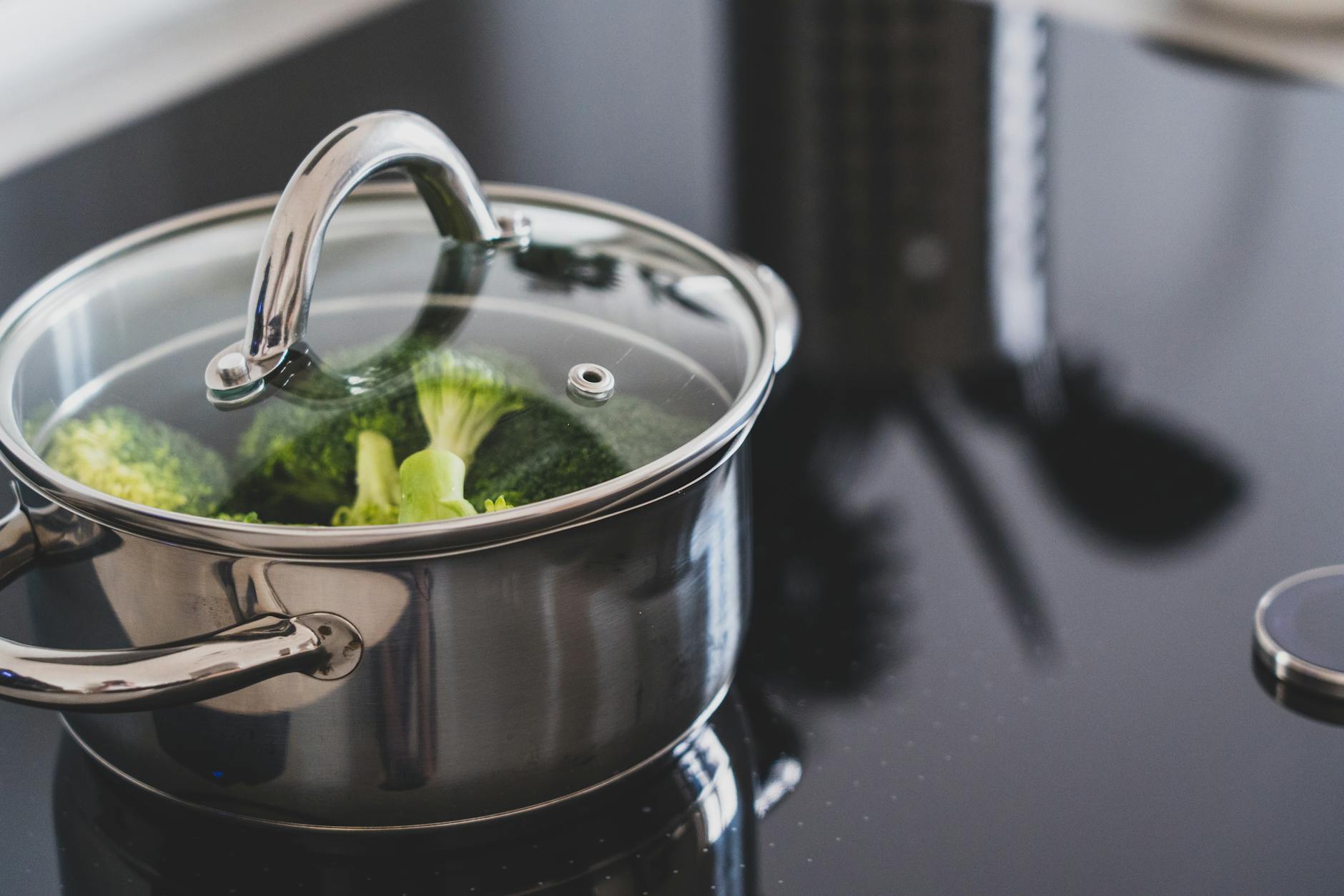 A compact home kitchen with a cutting board, one pot, and simple ingredients on the counter