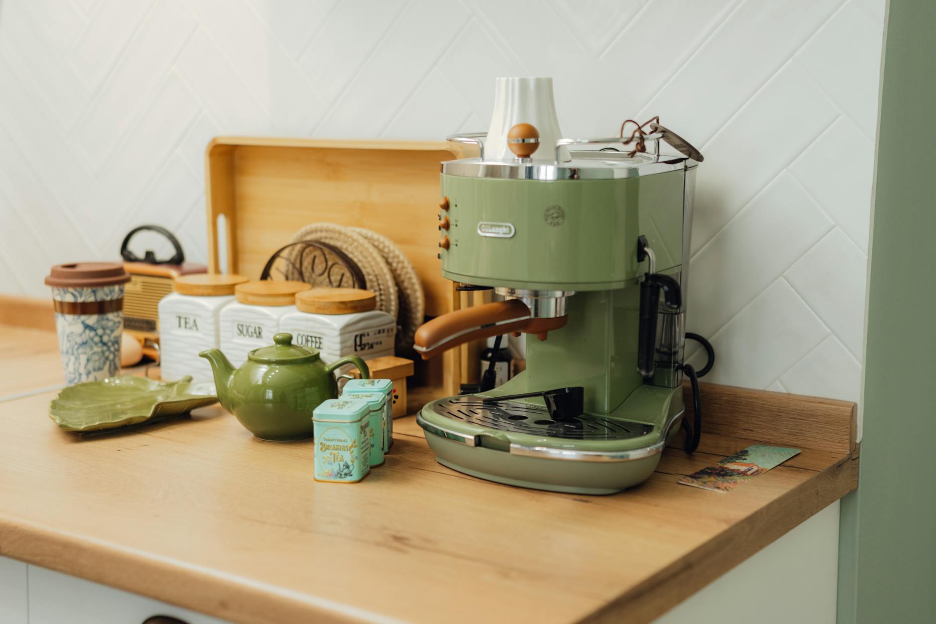 A cozy kitchen coffee corner with neutral mugs, a small tray, and a compact coffee setup